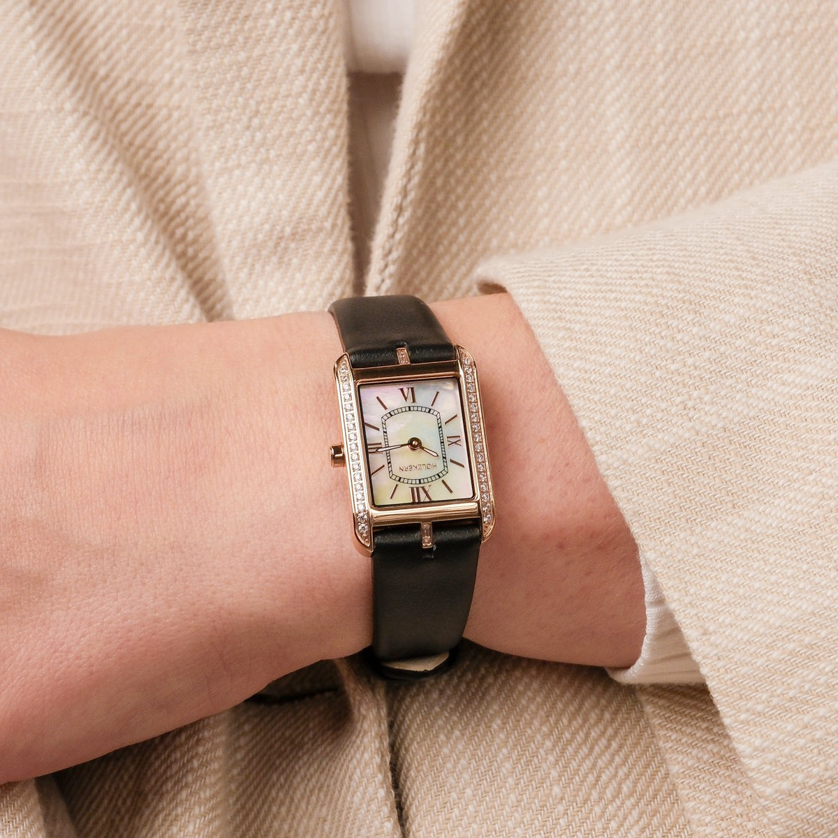 "Memoire" watch in nacre and black, featuring a classic rectangular face and elegantly detailing.