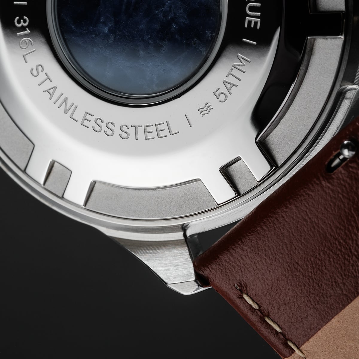 "Naturalist" watch featuring a marble and silver design with stainless steel back and leather strap.