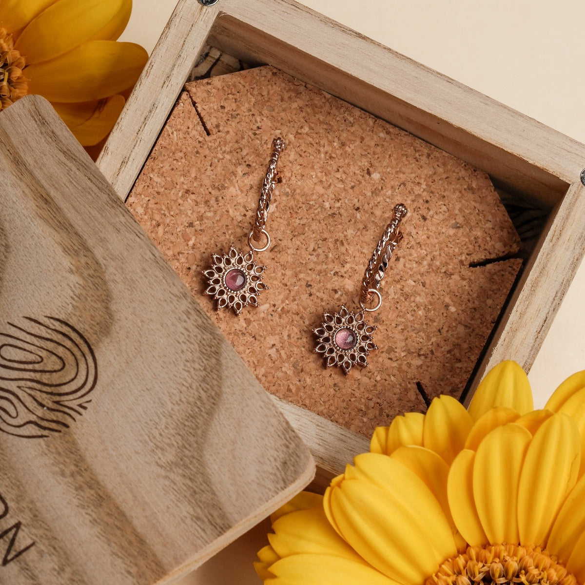 Suncatcher Earrings, elegant earrings featuring amethyst stones and rose gold accents in a sunburst design.