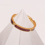 "Campania Ring" - a sleek, modern ring featuring maple wood and gold accents.