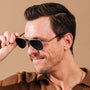 "The Badass I", stylish sunglasses with a walnut and matte gold finish, exuding a modern and sophisticated look.