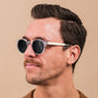 "The Hyped" sunglasses featuring a zebrawood and crystal design worn by a model.