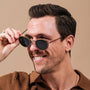 "The Radiant S" sunglasses feature a sleek walnut and copper design with a modern, stylish look.