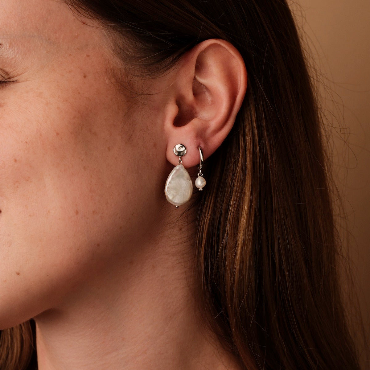 Summersweet earrings featuring baroque pearls and silver, showcasing an elegant and stylish design.