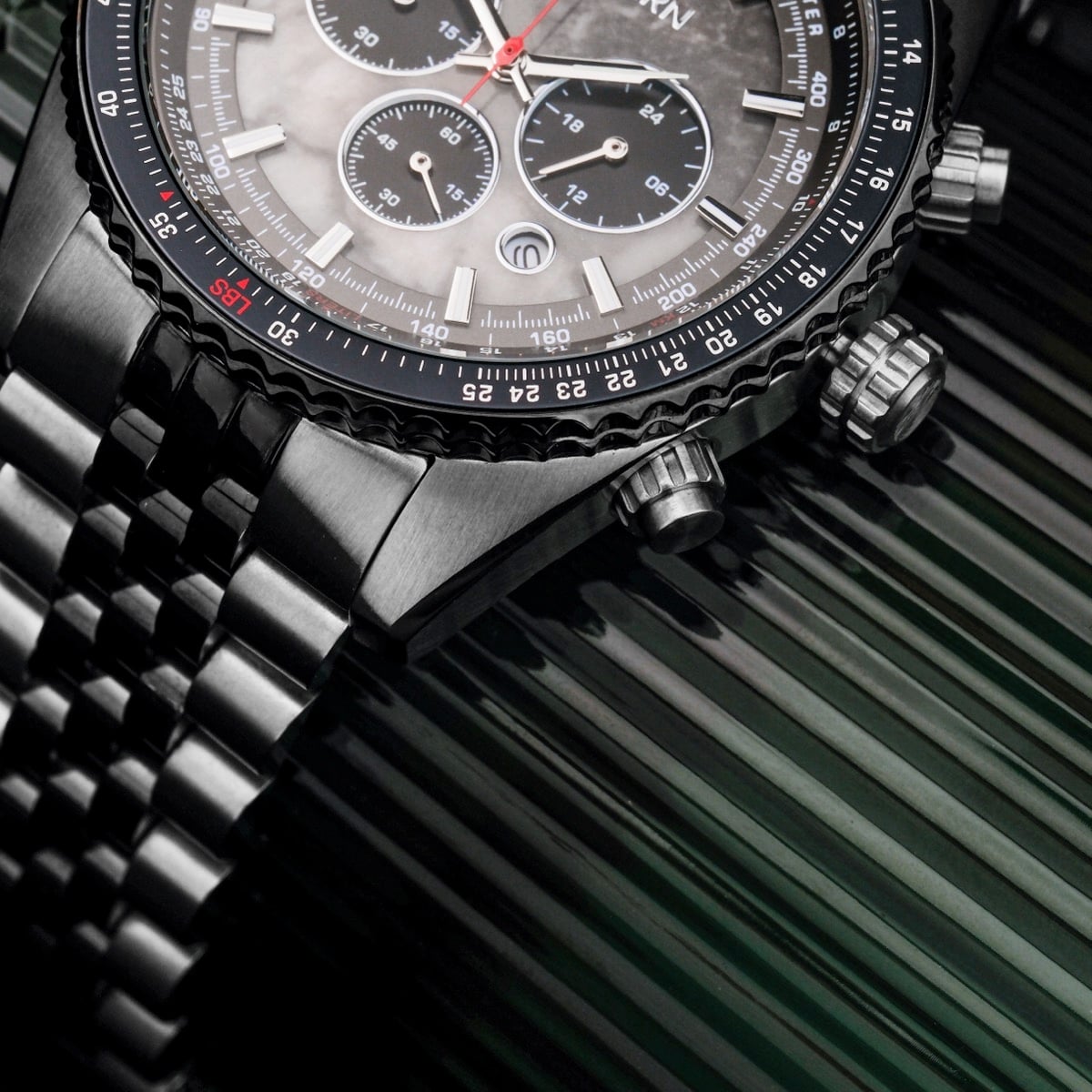 "Openhorizon" watch with gray marble face and silver accents, featuring a detailed chronograph design.