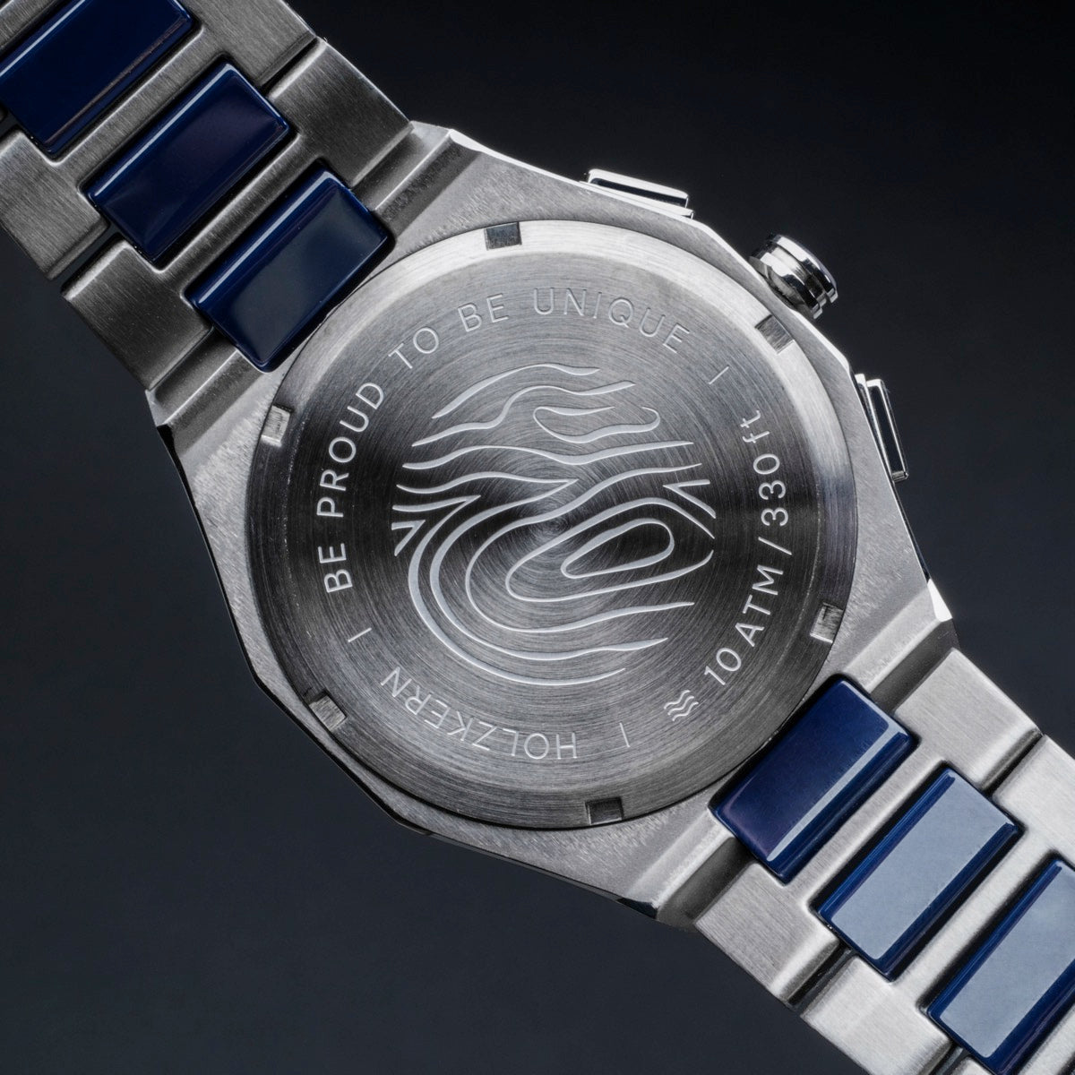 "Oceanswell" watch featuring a ceramic and silver design with engraved back showcasing unique style.