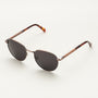 "The Achiever" sunglasses featuring a walnut and copper finish with a sleek, modern design.