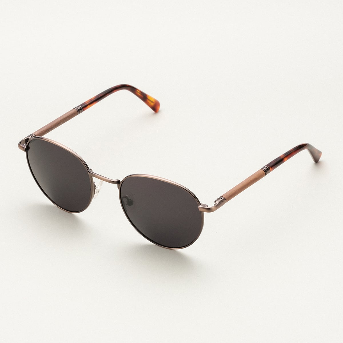 "The Achiever" sunglasses featuring a walnut and copper finish with a sleek, modern design.