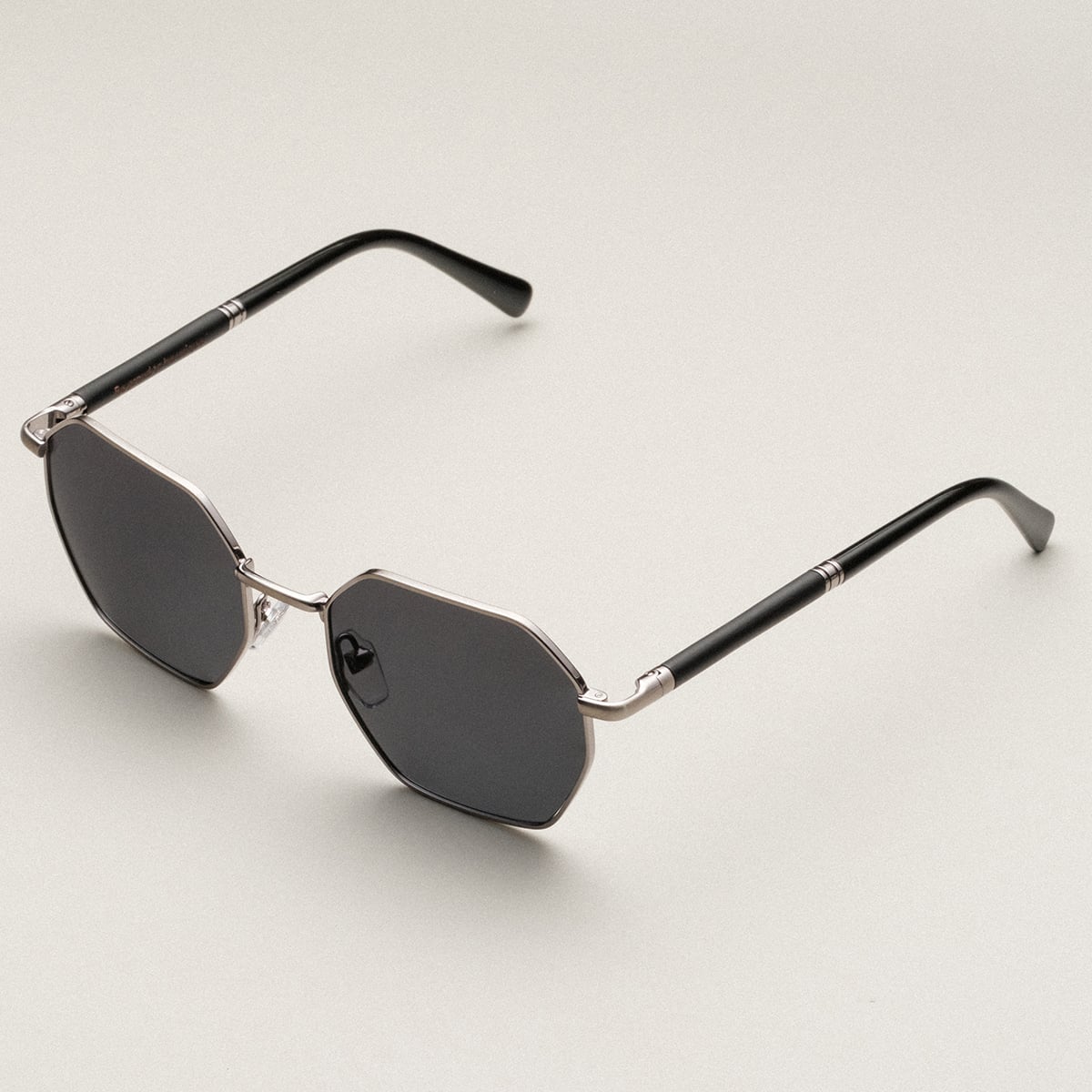"The Magical" sunglasses featuring a sleek maple finish with antique silver accents and dark lenses.