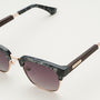 "The Virtuoso" sunglasses featuring a leadwood and black havana design with a sleek, modern style.