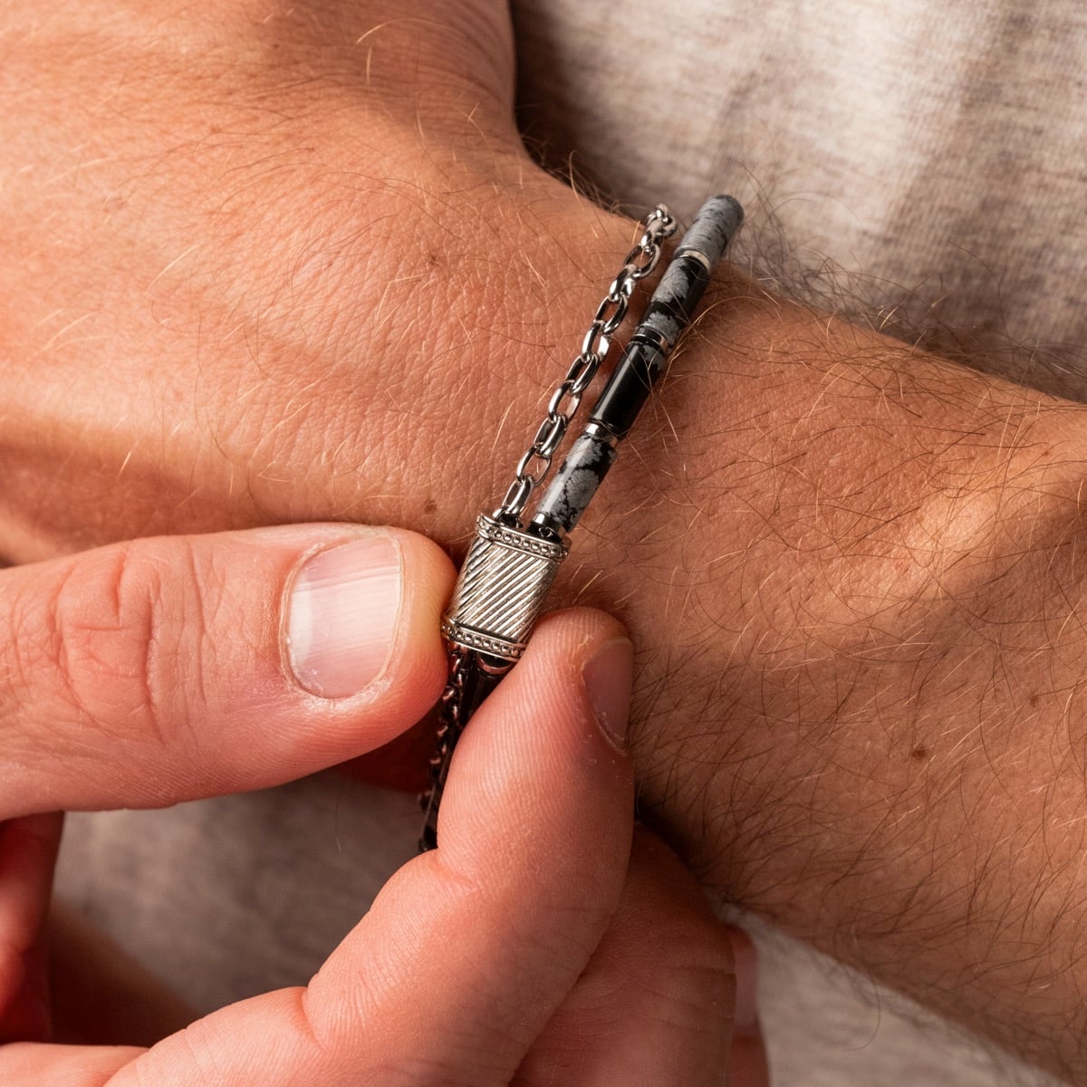 "Supersonic" bracelet featuring a sleek obsidian and silver design on a wrist.