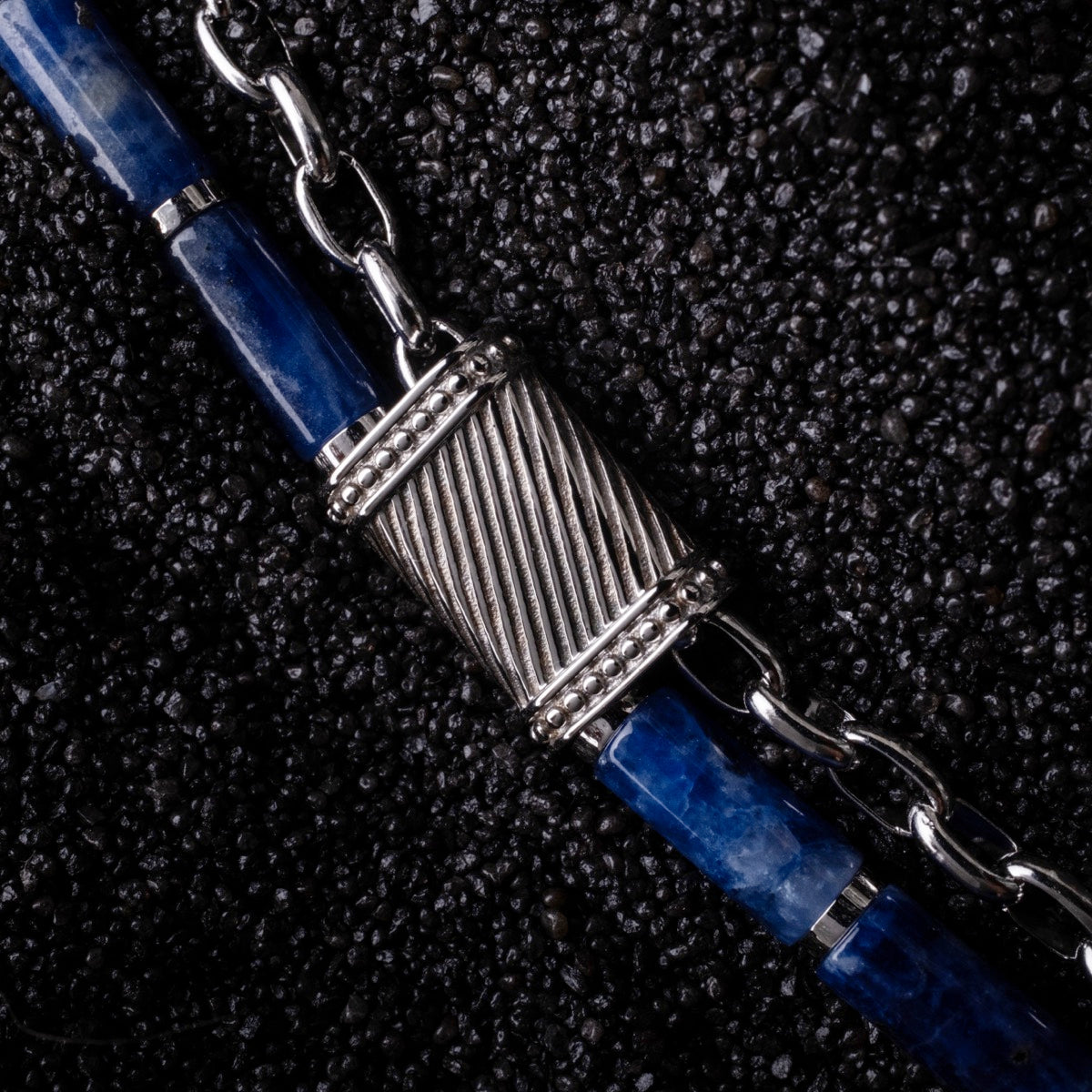 "Supersonic" bracelet featuring a marble and silver design on a textured background.