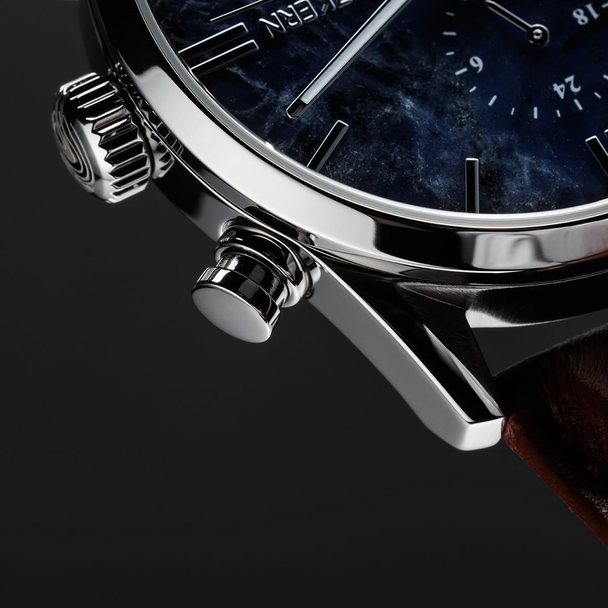 "Naturalist" wristwatch featuring a marble dial and silver accents with a sleek, modern design.
