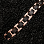 "Acoustic" bracelet featuring maple and rose gold accents on a textured black background.