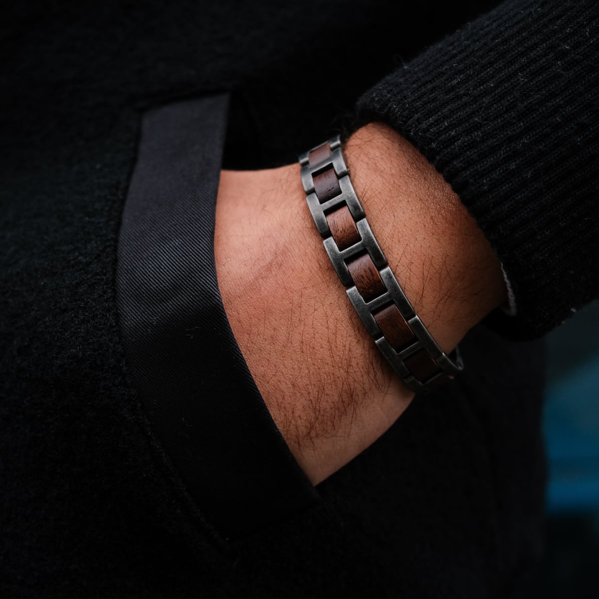 "Acoustic" bracelet featuring a walnut and antique silver design, worn on wrist against a dark textured background.
