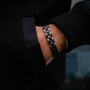 "Acoustic" bracelet featuring walnut and gray materials, offering a sleek and modern style.