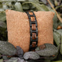 "Acoustic" bracelet featuring zebrawood and black links in a natural setting.