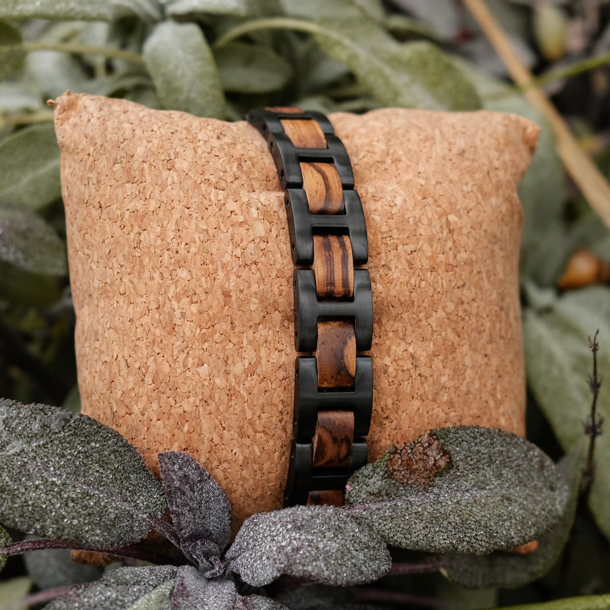 "Acoustic" bracelet featuring zebrawood and black links in a natural setting.