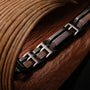 "Staccato", bracelet in walnut and antique silver, featuring a sleek, modern design.