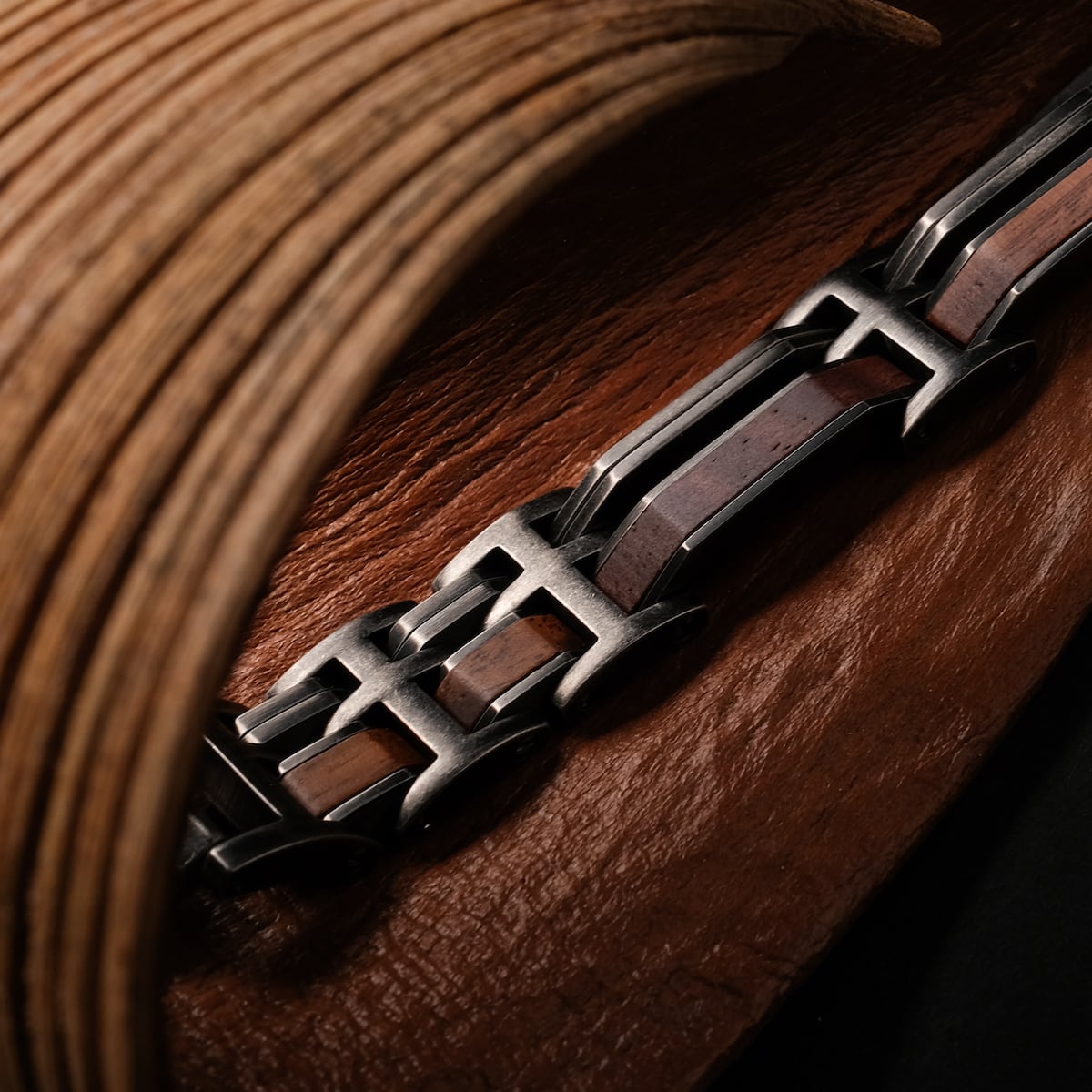 "Staccato", bracelet in walnut and antique silver, featuring a sleek, modern design.