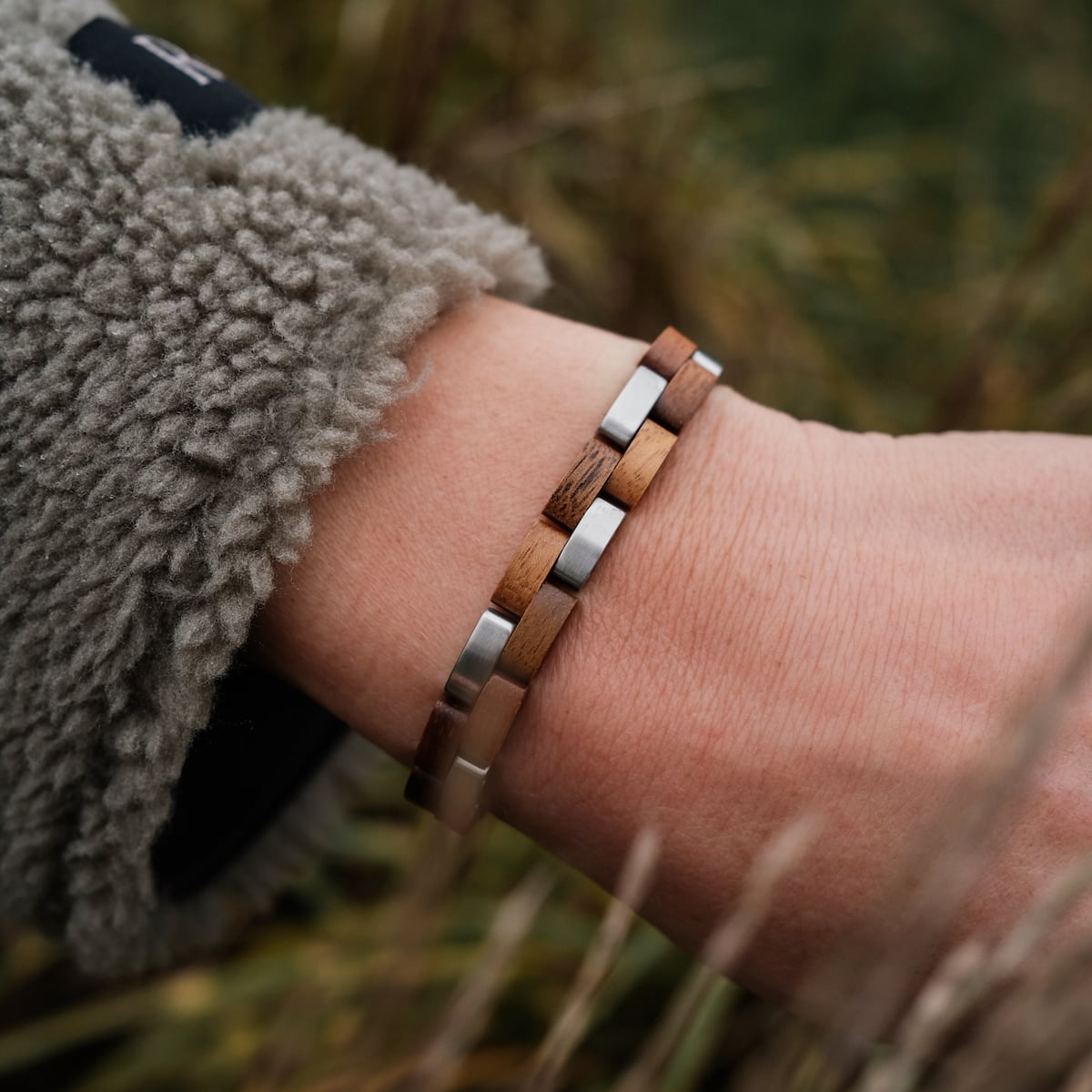 "Rondo" bracelet in Koa wood and silver, showcasing a stylish and natural design.