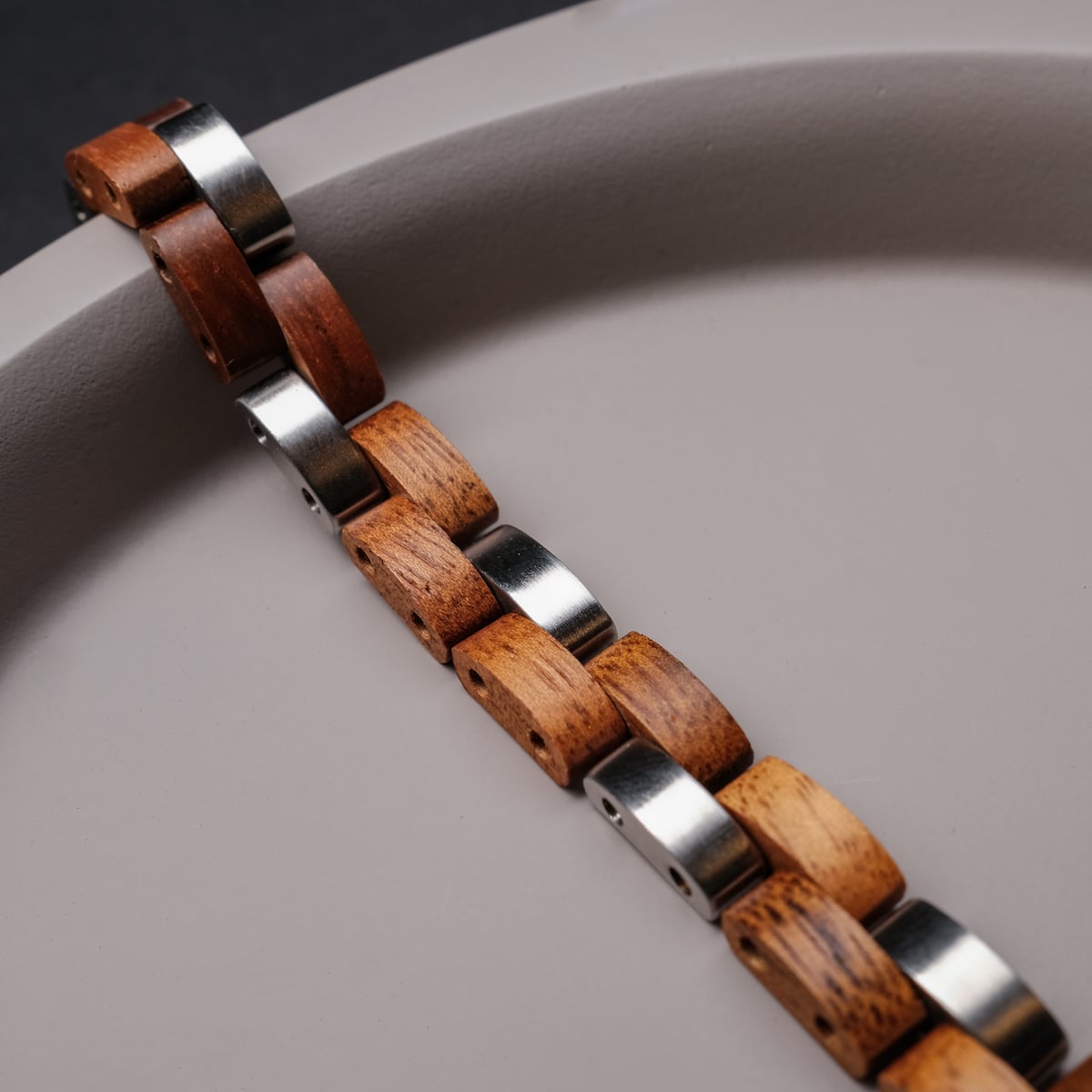 "Rondo" bracelet featuring koa wood and silver accents in a modern, elegant style.