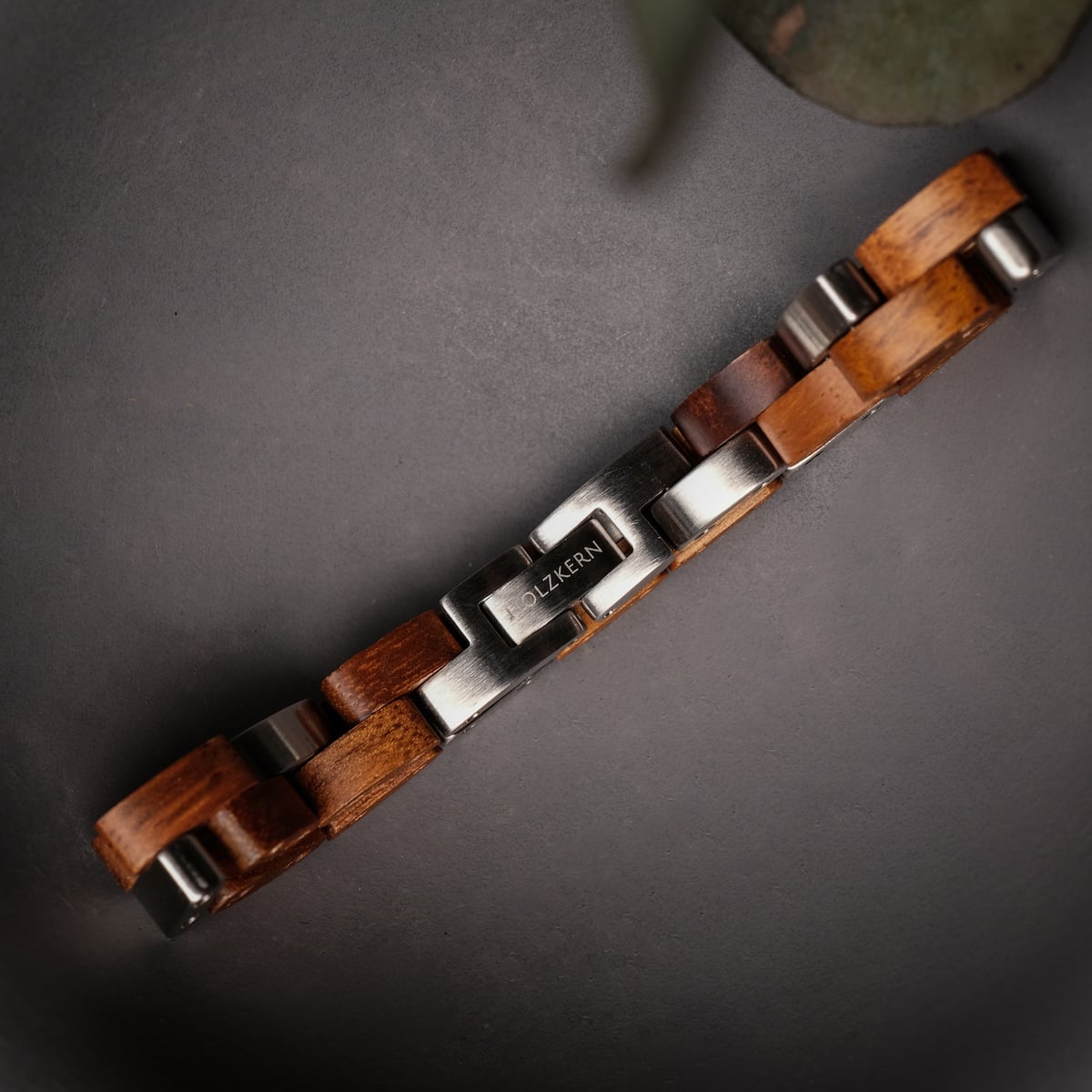 "Rondo" bracelet featuring koa wood and silver, with a sleek and modern design.