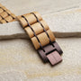 "Grandezza" wooden bracelet, featuring maple and dark purple hues, in a natural, textured style.