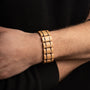 "Grandezza" wooden bracelet in maple and dark purple, showcasing a sleek and modern design on wrist.