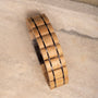 "Grandezza" bracelet, featuring maple and dark purple materials in a sleek, modern design.