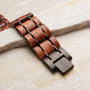 "Grandezza watch strap featuring a mahogany and gray design with a natural wood grain finish."