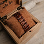 "Grandezza watch with a mahogany and gray design, nestled in a cork-lined wooden box."