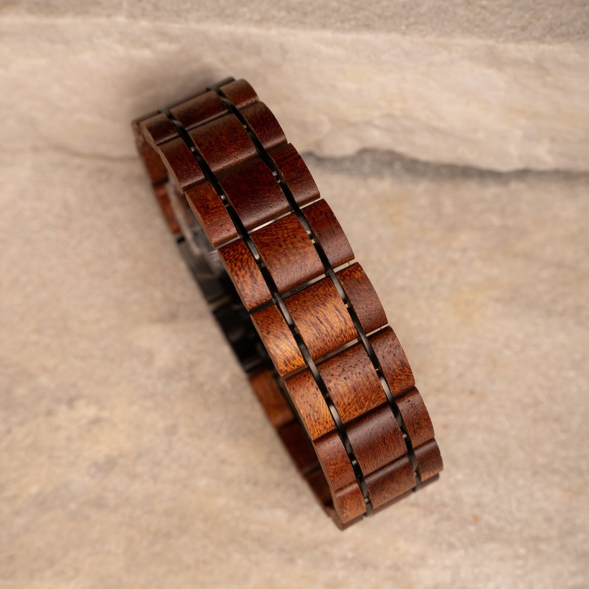 "Grandezza wristband, featuring mahogany and gray tones in a sleek, geometric design."