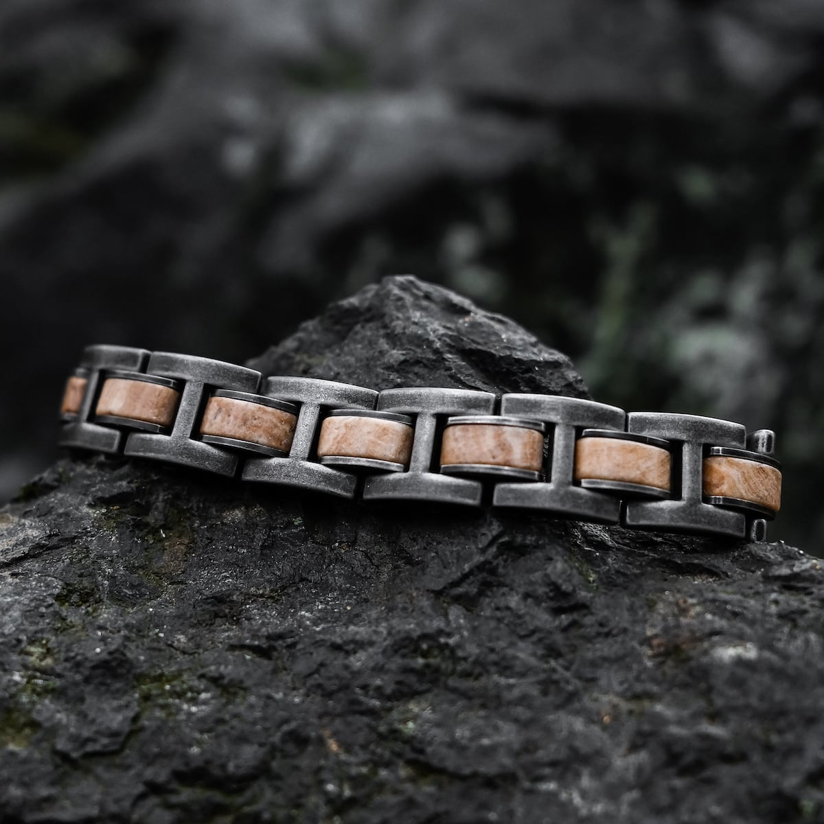 "Forte" bracelet featuring a rugged marble and antique-silver design on a textured rock background.
