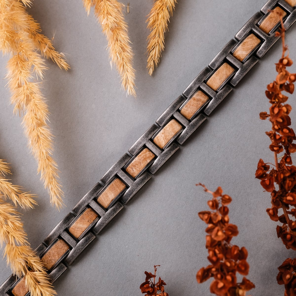 "Forte" bracelet featuring a marble and antique silver design, styled with natural earthy elements for a sophisticated look.
