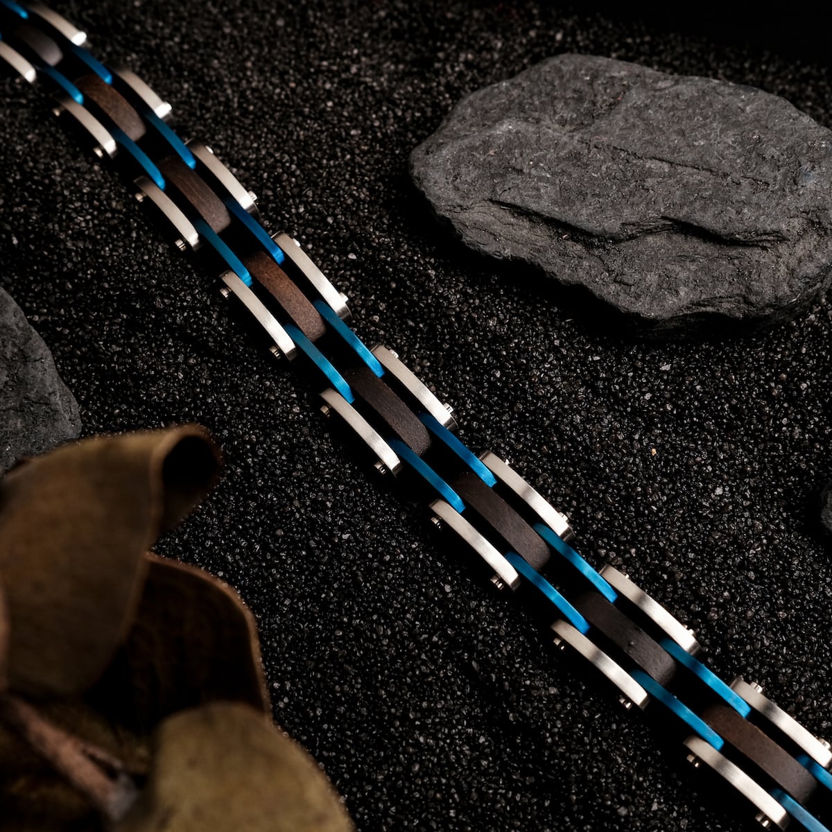 "Allegro" bracelet featuring a sleek maple and silver design amidst a textured backdrop.