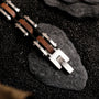 "Allegro" bracelet, featuring a sleek walnut and silver design on a textured surface.
