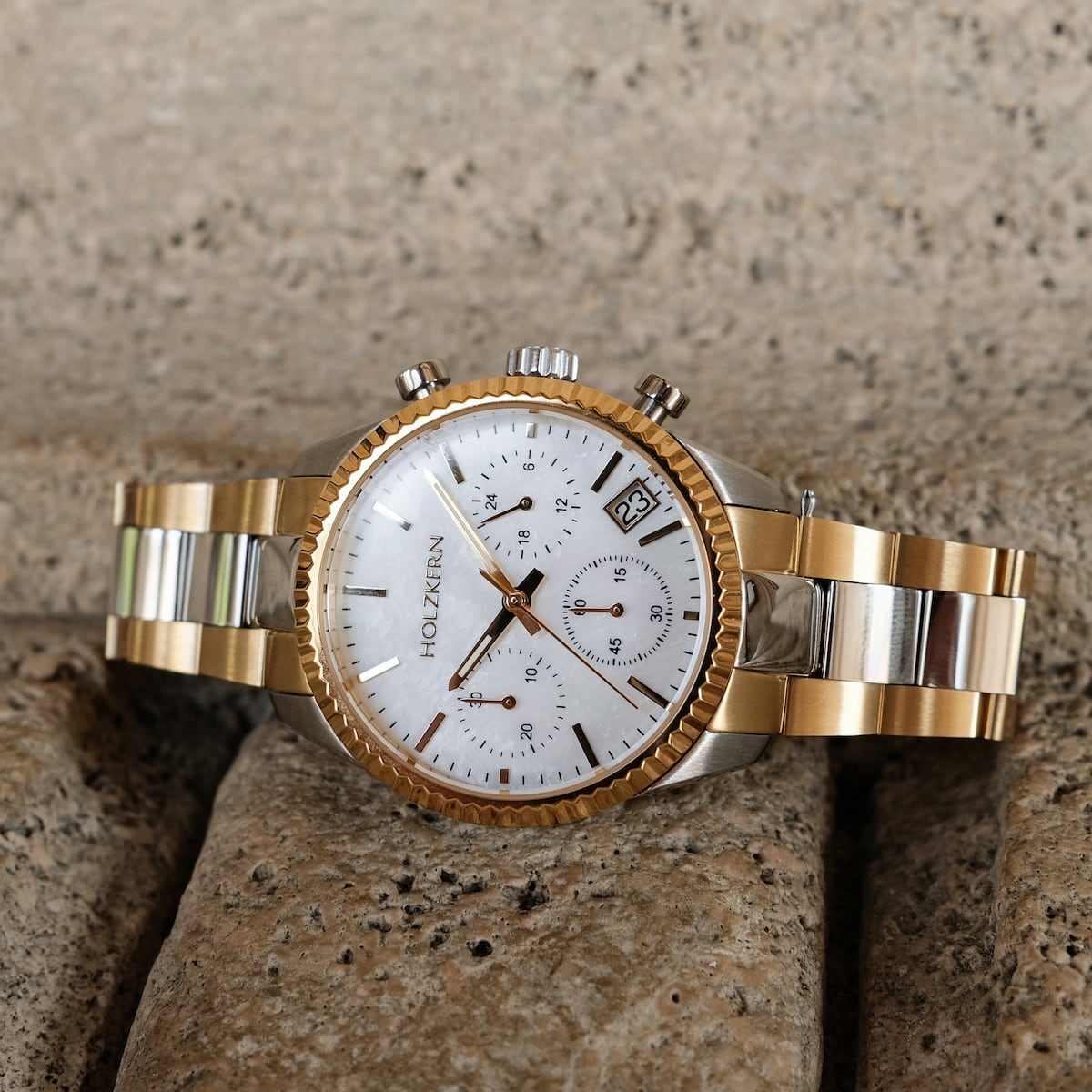 "The Supportive" luxury watch with nacre and gold tones, showcasing a sleek and elegant design.