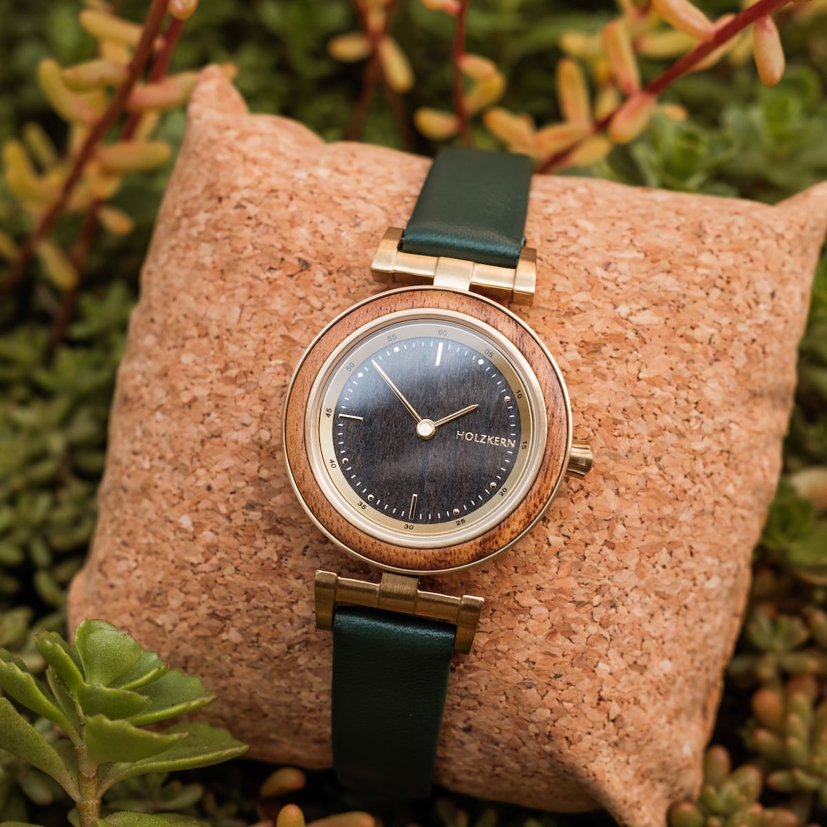 "Amelia" wristwatch with a Marblewood and Maple finish, featuring a dark face and elegant green strap.