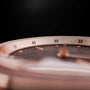 "Harriet", a sleek watch with a walnut and maple design featuring a detailed, minimalist face and subtle metallic accents.