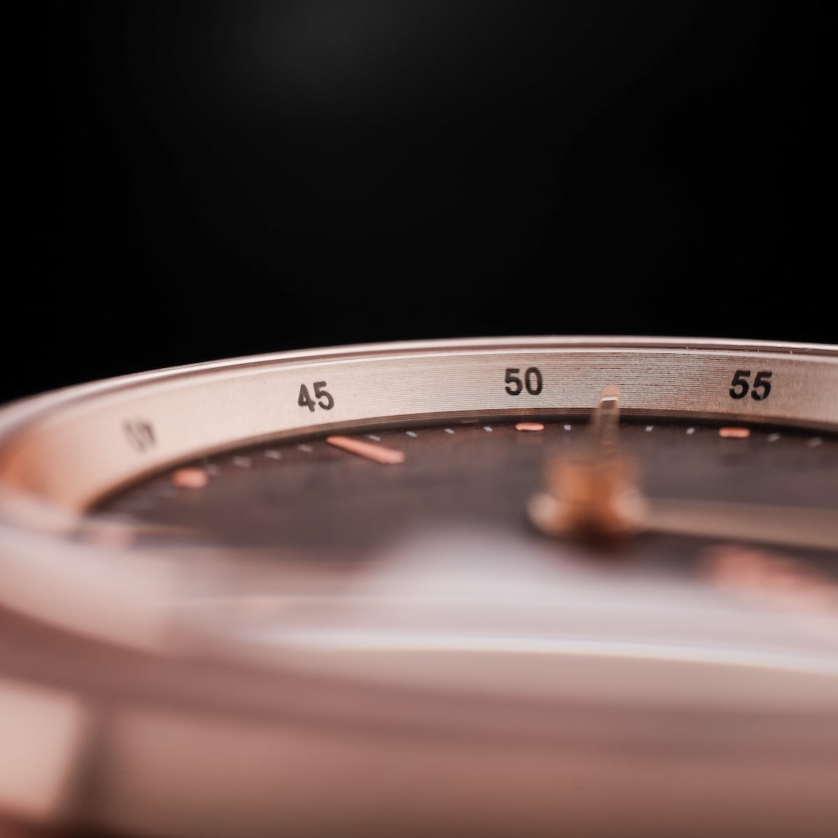 "Harriet", a sleek watch with a walnut and maple design featuring a detailed, minimalist face and subtle metallic accents.