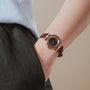 "Harriet", a stylish wristwatch made of walnut and maple, with a sleek and minimalist design.