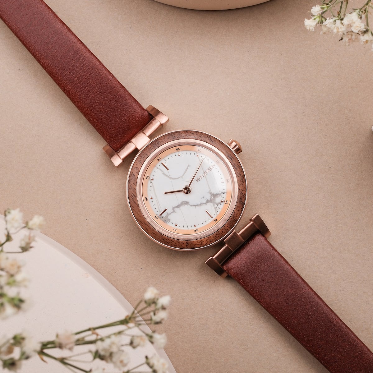 "Ida" watch featuring a walnut case and marble dial, complemented by a sleek leather strap.