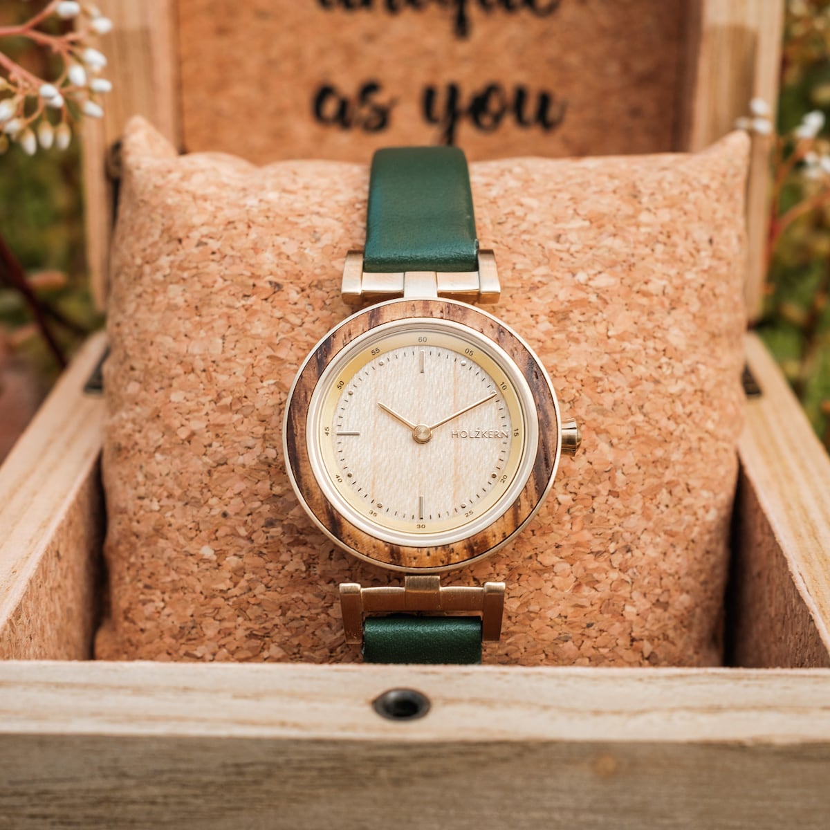"Laura" wooden watch with a stylish zebrawood and oak design, featuring a green leather strap.