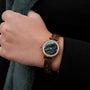 "Euterpe" watch features a walnut and marble design with a sleek, modern aesthetic.