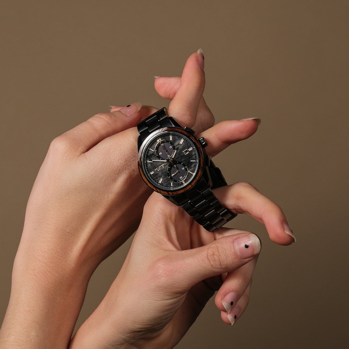 "Endowment" Watch, featuring a Marble and Zebrawood design, hero in Hands Against a Neutral Background.