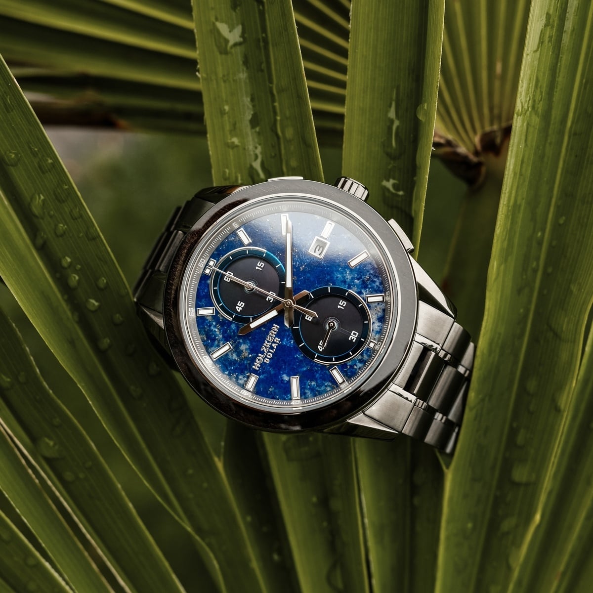 "Uplift" watch featuring a Lapis Lazuli dial and Maple accents, styled on a leafy background.