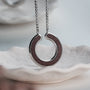 "Inseparable S" necklace, featuring a walnut and silver finish, with an elegant circular design.