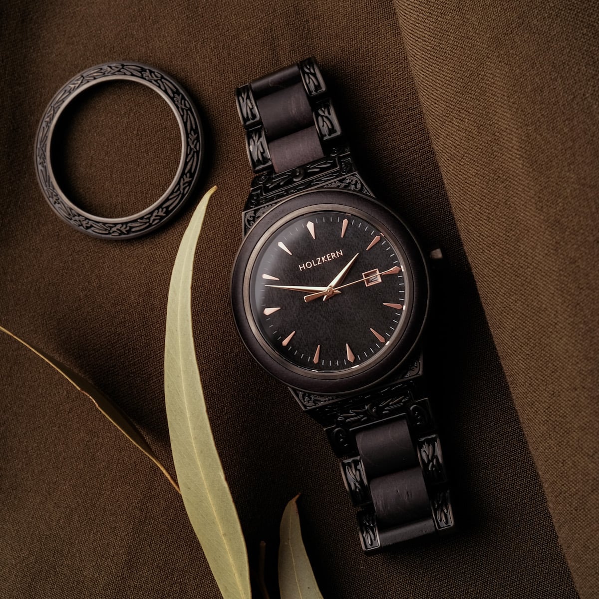 "Khalili" watch with black dial, intricate design, and maple accents for an elegant style.