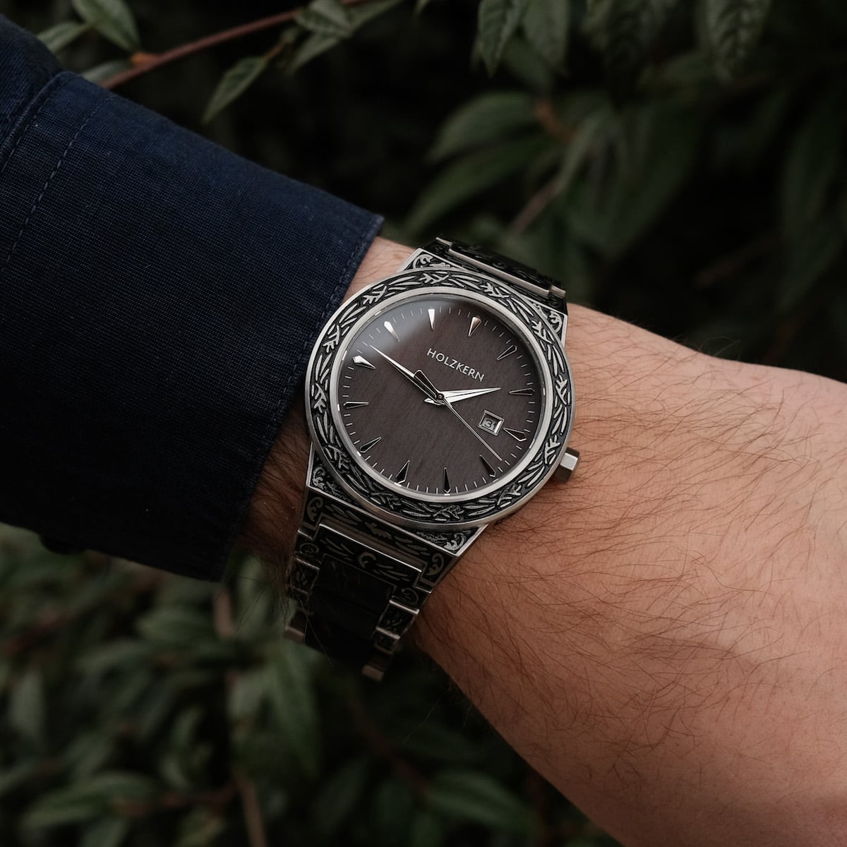"Misir" watch featuring a detailed engraved metal design and a sleek, modern style.